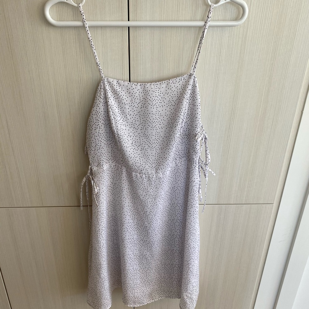 White polka dot mini dress with side tie detail